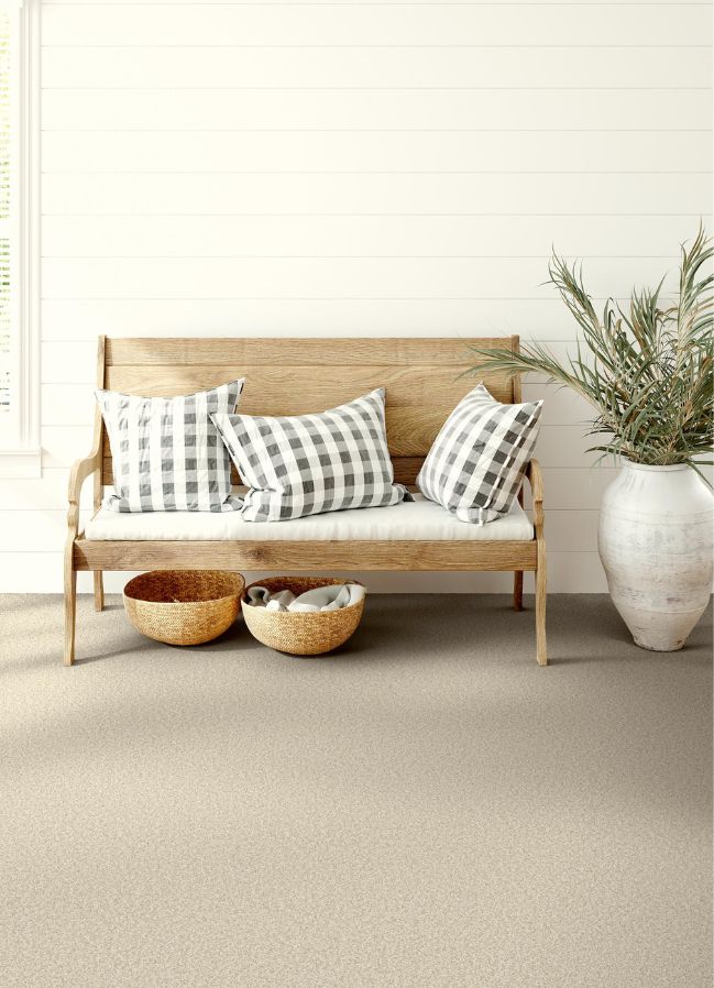 carpet in a hallway with a bench