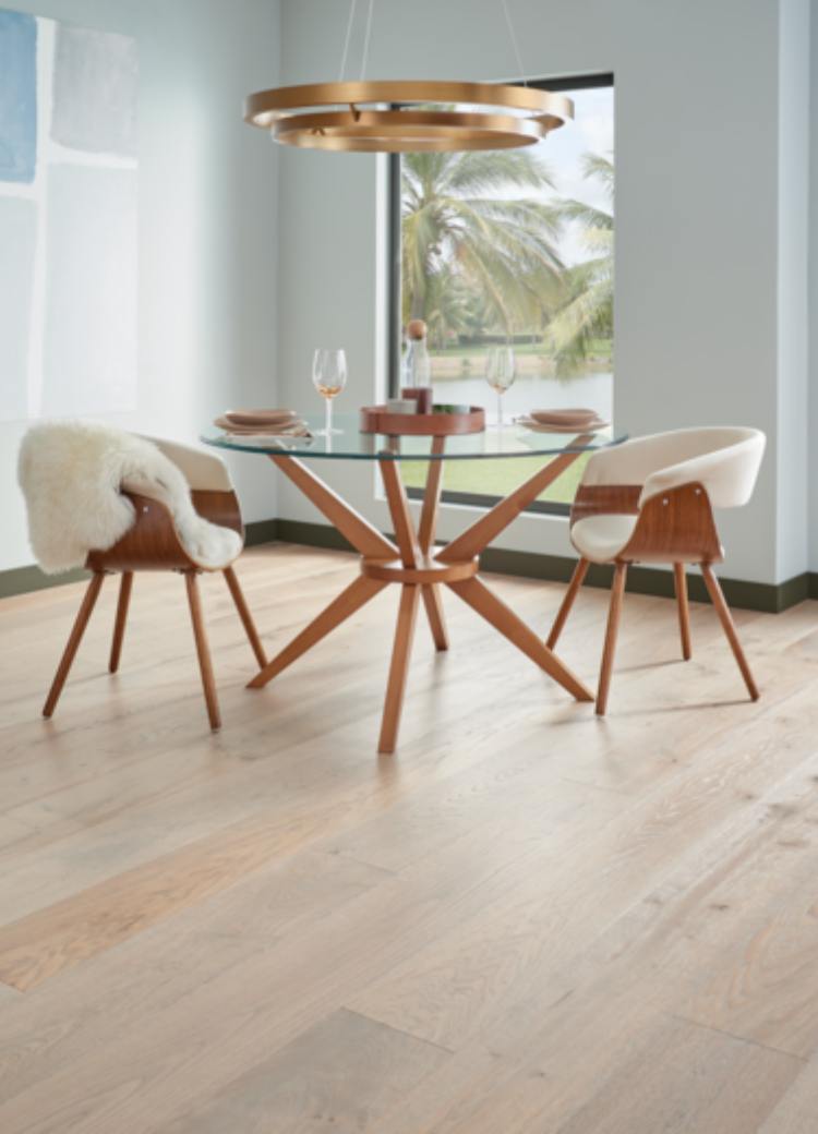 warm toned hardwood flooring in dining room with wood and glass table and wood chairs.